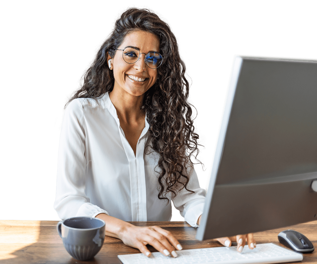 Woman smiling at a computer while typing
